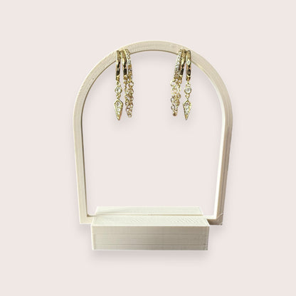 Nitelief gold hoop earrings featuring delicate dangling chains and sparkling crystal-encrusted geometric charms.