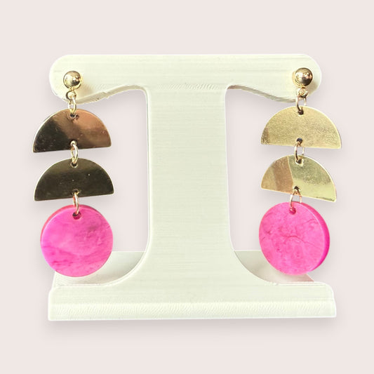 Nitelief gold-tone metal semi-circle and pink circular resin drop earrings displayed on a white stand